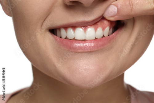 Woman showing healthy gums on white background  closeup
