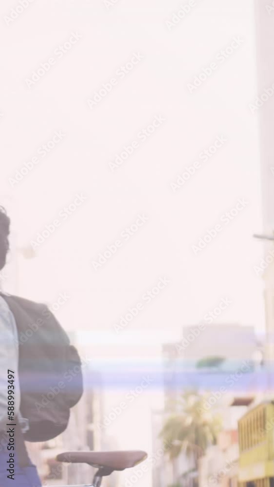Animation of light spots over biracial woman with face mask walking with bicycle Animation of light spots over biracial woman with face mask walking with bicycle