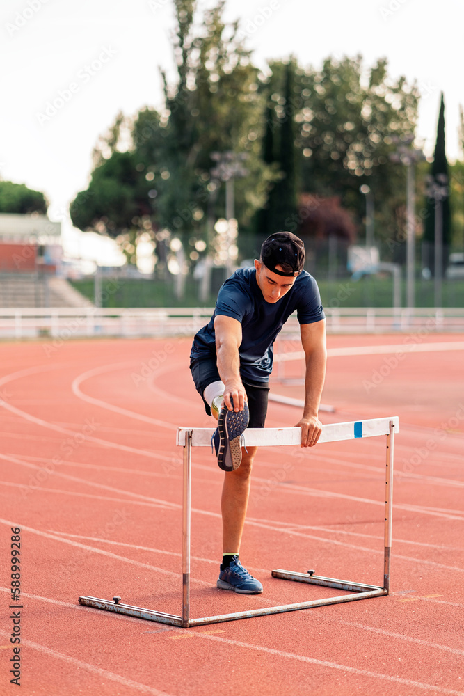 Disabled man athlete stretching with leg prosthesis.