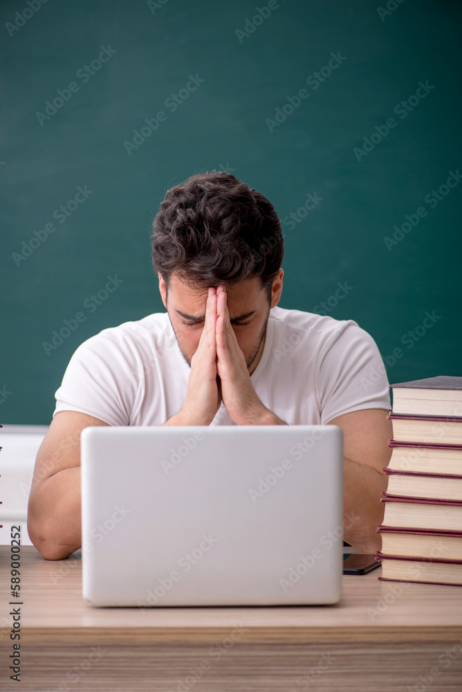 Young male student sitting in the classroom Young male student sitting in the classroom