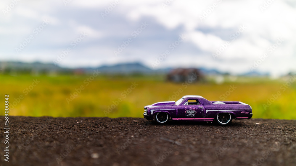 minahasa, Indonesia : January 2023, toy car in the rice field minahasa, Indonesia : January 2023, toy car in the rice field