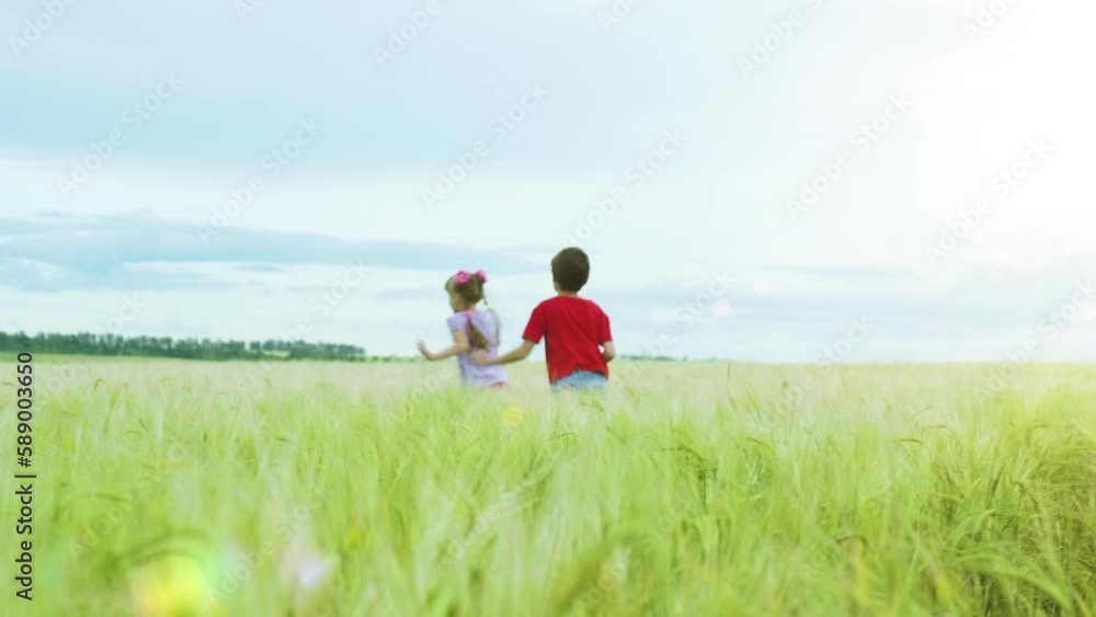 Best friends Little Boy and Girl Running Carefree in the Summer Meadow. Playing Catch-up. The Concept of a Happy Carefree Childhood Best friends Little Boy and Girl Running Carefree in the Summer Meadow. Playing Catch-up. The Concept of a Happy Carefree Childhood