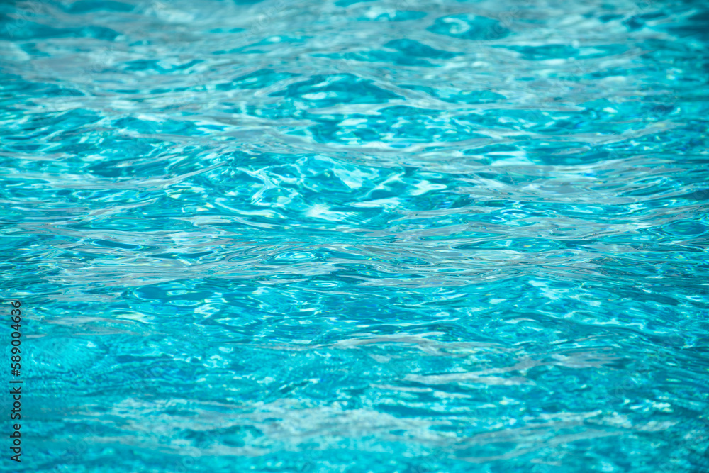 Background of blue water in swimming pool with sun reflection, ripple water wave in pool. Clear water background. Background of blue water in swimming pool with sun reflection, ripple water wave in pool. Clear water background.