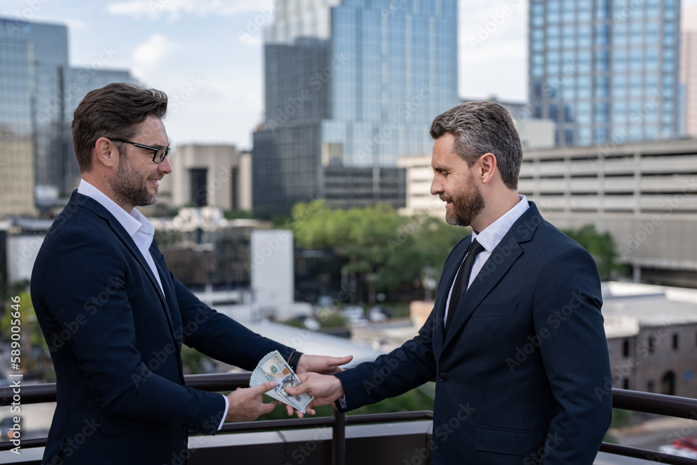 Two business team men. Businessmen giving money. Business man offering money for collage. Offering money for business. Two business team men. Businessmen giving money. Business man offering money for collage. Offering money for business.