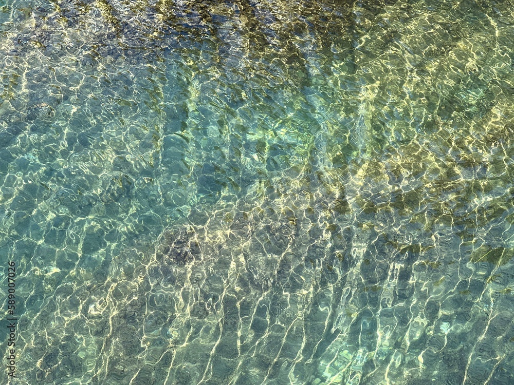 Naklejka premium Beautiful sea water with glittering clear light turquoise surface.