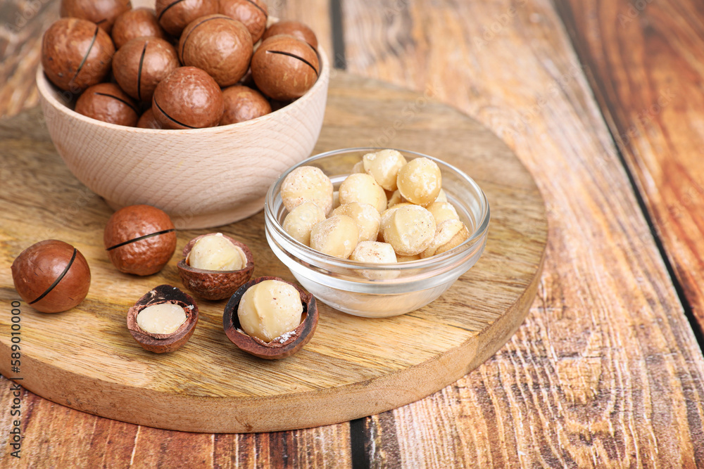 Delicious organic Macadamia nuts on wooden table Delicious organic Macadamia nuts on wooden table