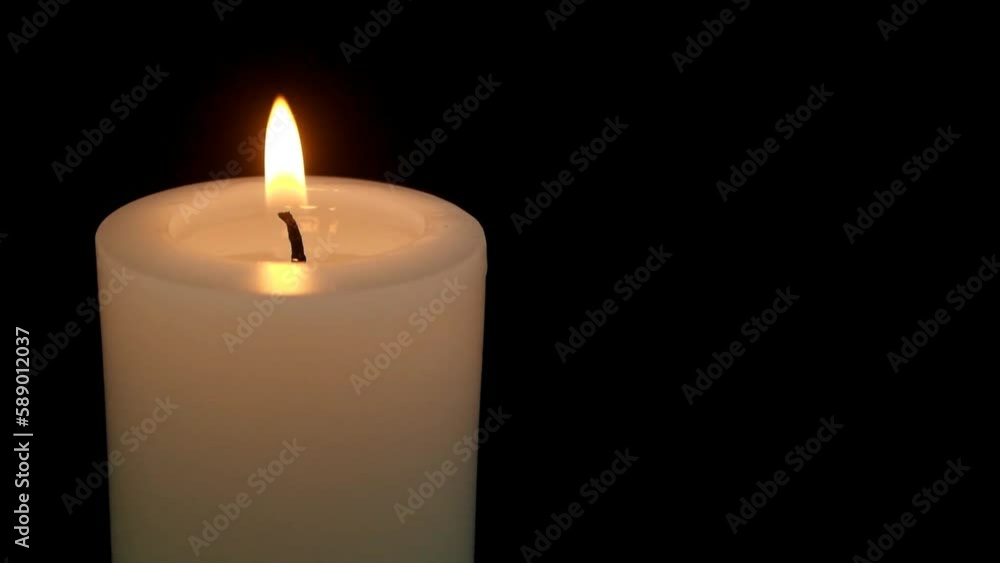 Burning candle isolated on black background close up. Copy space for text. Burning candle isolated on black background close up. Copy space for text.