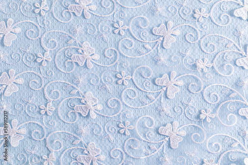 Delicate blue textile background with white colors. lace background. © Marina