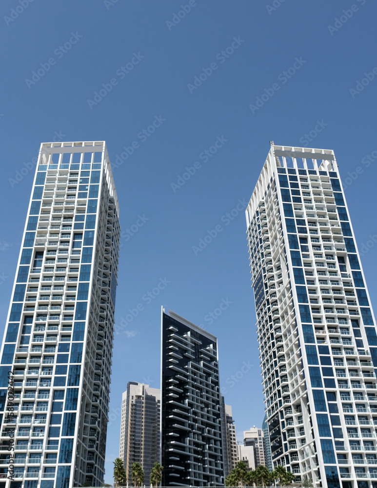 Futuristic and modern commercial and residential highrise tower skyscraper architecture with glass facades and clean lines in downtown Dubai, United Arab Emirates for millionaires and high society Futuristic and modern commercial and residential highrise tower skyscraper architecture with glass facades and clean lines in downtown Dubai, United Arab Emirates for millionaires and high society