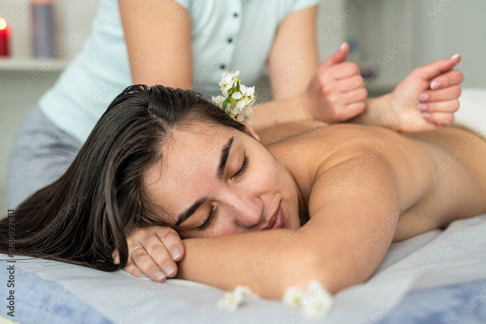 female masseur doing anti-cellulite massage for lose weight on back to woman client female masseur doing anti-cellulite massage for lose weight on back to woman client