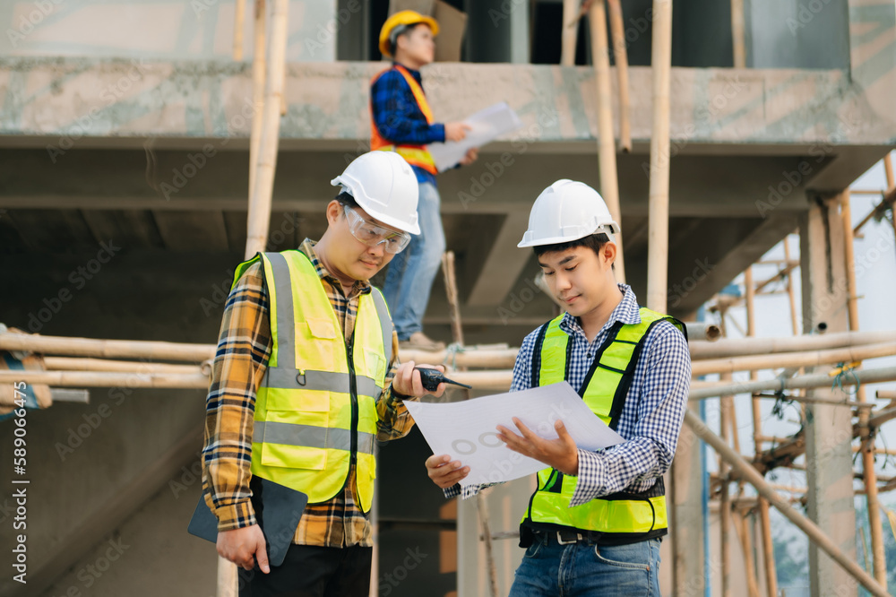 Architect caucasian man working with colleagues mixed race in the construction site. Architecture engineering on big project. Building in construction interior. Architect caucasian man working with colleagues mixed race in the construction site. Architecture engineering on big project. Building in construction interior.