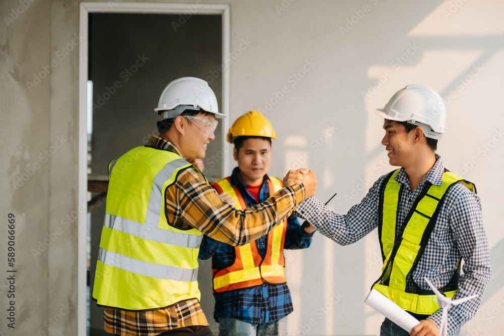 Engineer desk with object paper and tablet with blurry engineer teamwork hardworking to consults about their building project.. Engineer desk with object paper and tablet with blurry engineer teamwork hardworking to consults about their building project..