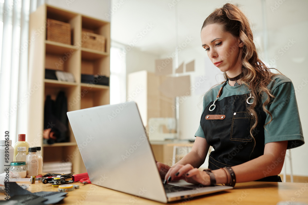 Leather craft workshop owner filling data on website Leather craft workshop owner filling data on website
