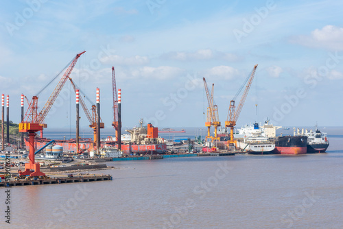 Shipyard, panorama view on the dockyard with cranes and ships.