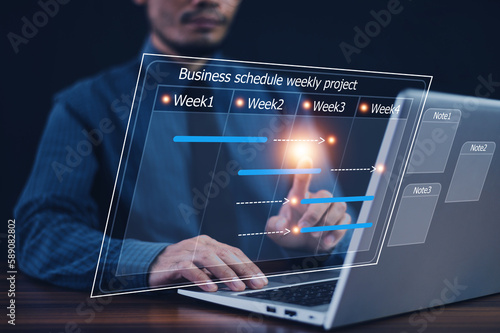 Businessman using computer for project business schedule by weekly, Business plan management concept