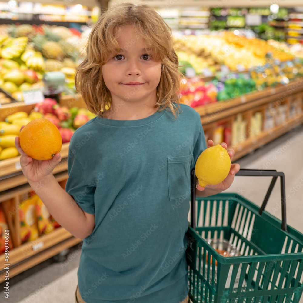 child-with-lemon-and-orange-kid-in-a-food-store-or-a-supermarket