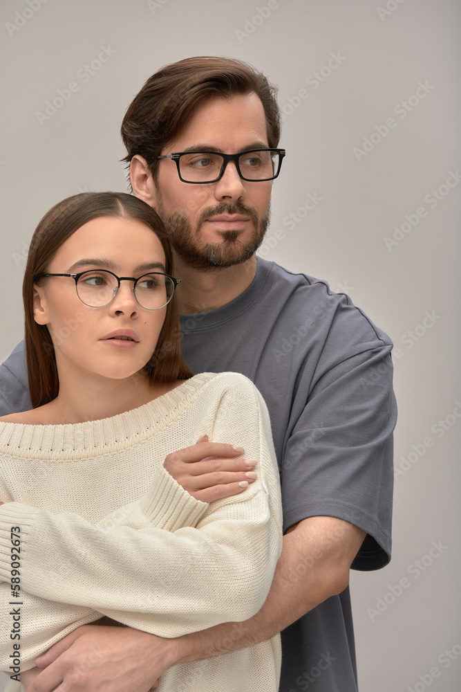 Close-up of an embracing couple in glasses, a man and a woman 25-35 years old are hugging on camera, the relationship between a girl and a guy Close-up of an embracing couple in glasses, a man and a woman 25-35 years old are hugging on camera, the relationship between a girl and a guy