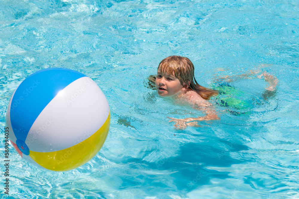 Child swimming in pool play with floating ring. Smiling cute kid in sunglasses swim with inflatable rings in pool in summer day.