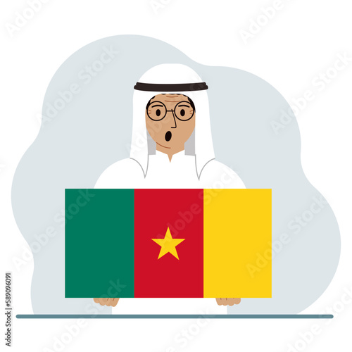 A man holds the flag of Cameroon in his hands. The concept of demonstration, national holiday or patriotism. Nationality.