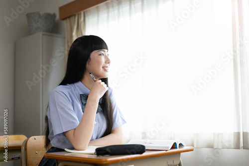 Fotografie Image of high school girls studying in short sleeves Summer classes, etc