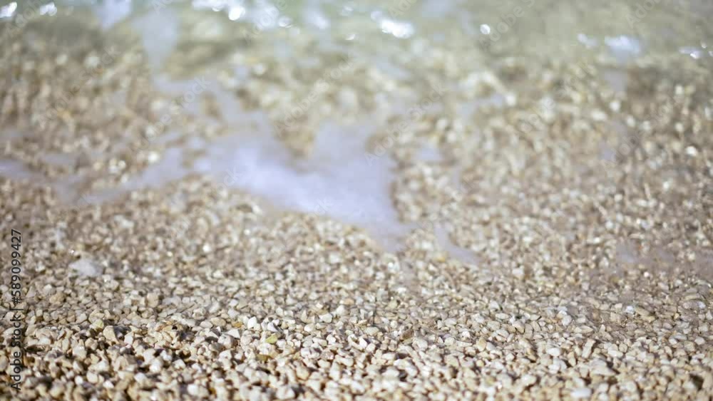 Close-up cinematic shot. Small waves on the seashore. Close-up cinematic shot. Small waves on the seashore.