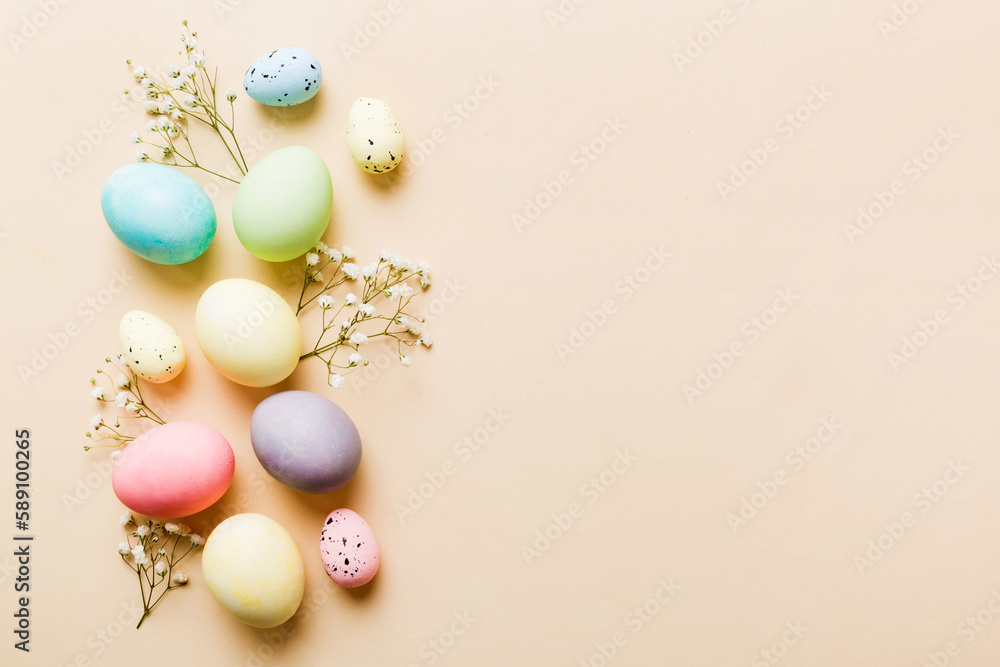 Happy Easter composition. Easter eggs on colored table with gypsophila. Natural dyed colorful eggs background top view with copy space Happy Easter composition. Easter eggs on colored table with gypsophila. Natural dyed colorful eggs background top view with copy space