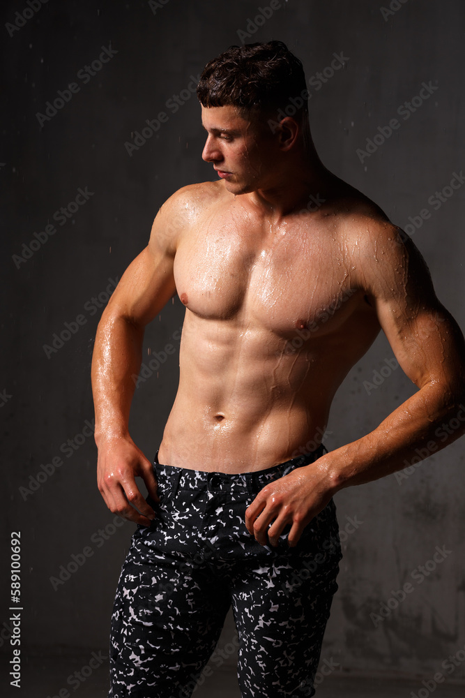 Fototapeta premium A guy in a great sports uniform in the studio on a gray background.