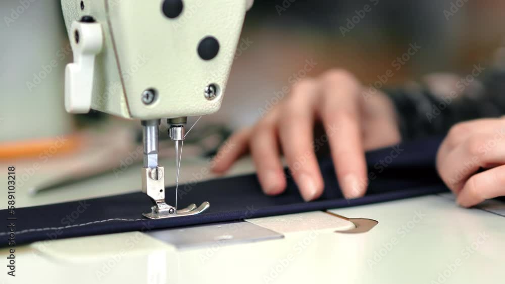 Female dressmaker hands sews textile details electric sewing machine dressmaking manufacture
