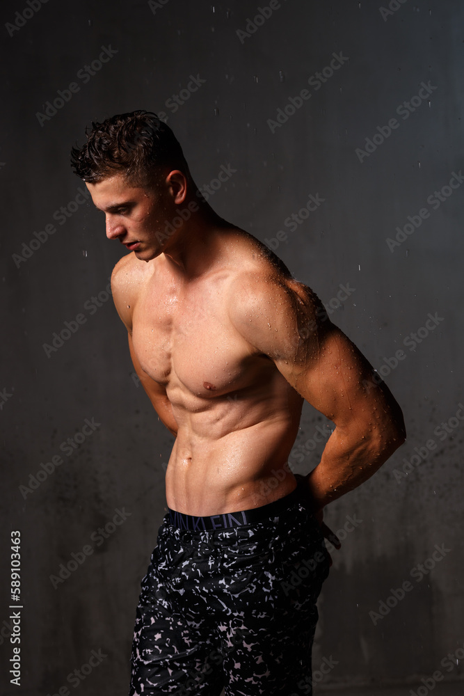 Fototapeta premium A guy in a great sports uniform in the studio on a gray background.