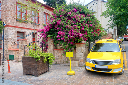 Yellow taxi on a street corner in the old district of Antalya.