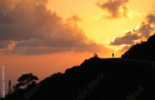 View of a person at sunset along the top of the road on the Carmel mountain  Haifa  Israel