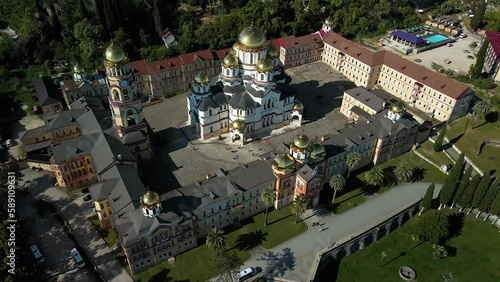 Aerial video New Athos, New Athos, Abkhazia. Resort town between mountains and sea. Beautiful view from the drone to the sea, the city and the monastery