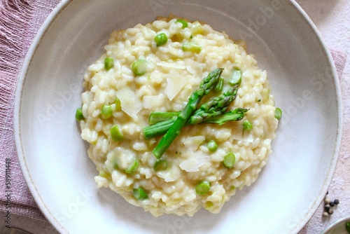 Italian risotto with asparagus and parmesan cheese on table. Top view.
