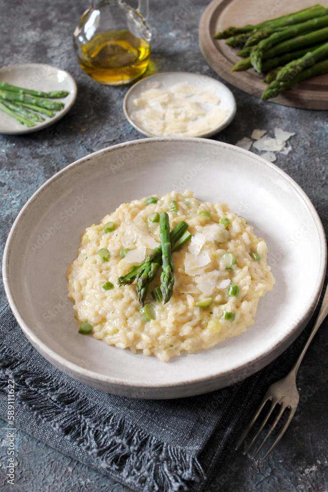 Italian risotto with asparagus and parmesan cheese on table. Top view. Italian risotto with asparagus and parmesan cheese on table. Top view.
