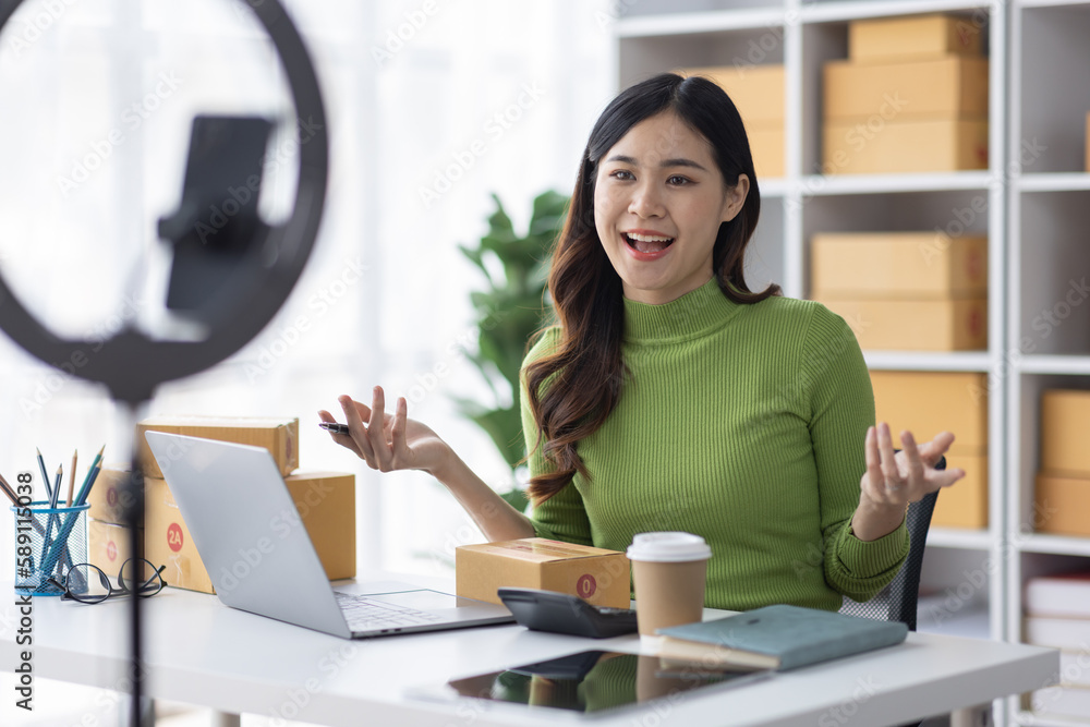 Startup SME small business entrepreneur freelance Asian woman using a laptop with box merchant seller checking customer address order confirming parcel SME delivery idea concept. Startup SME small business entrepreneur freelance Asian woman using a laptop with box merchant seller checking customer address order confirming parcel SME delivery idea concept.