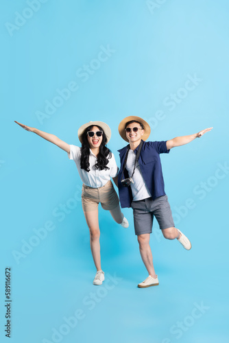 Asian couple traveling image isolated on blue background