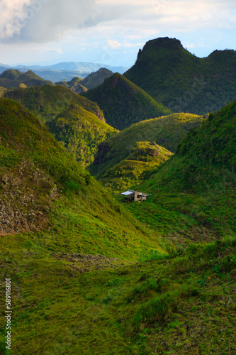 Osmena Peak in the Philipines, green landscape in the mountains. A mountain view from Cebu island. Osmeña Peak. Clouds in Filipinas. Lonely house in philipines. portrait 