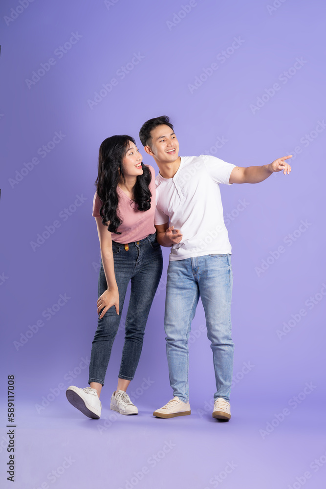 full body image of asian couple posing on purple background full body image of asian couple posing on purple background