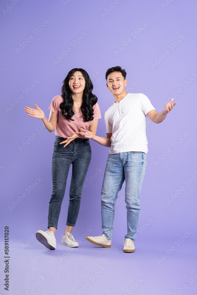 Fototapeta premium full body image of asian couple posing on purple background