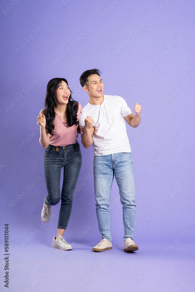 full body image of asian couple posing on purple background full body image of asian couple posing on purple background