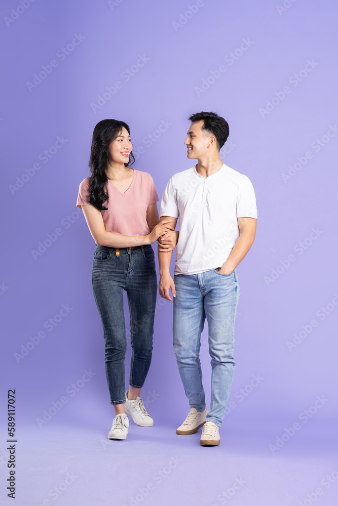 full body image of asian couple posing on purple background full body image of asian couple posing on purple background