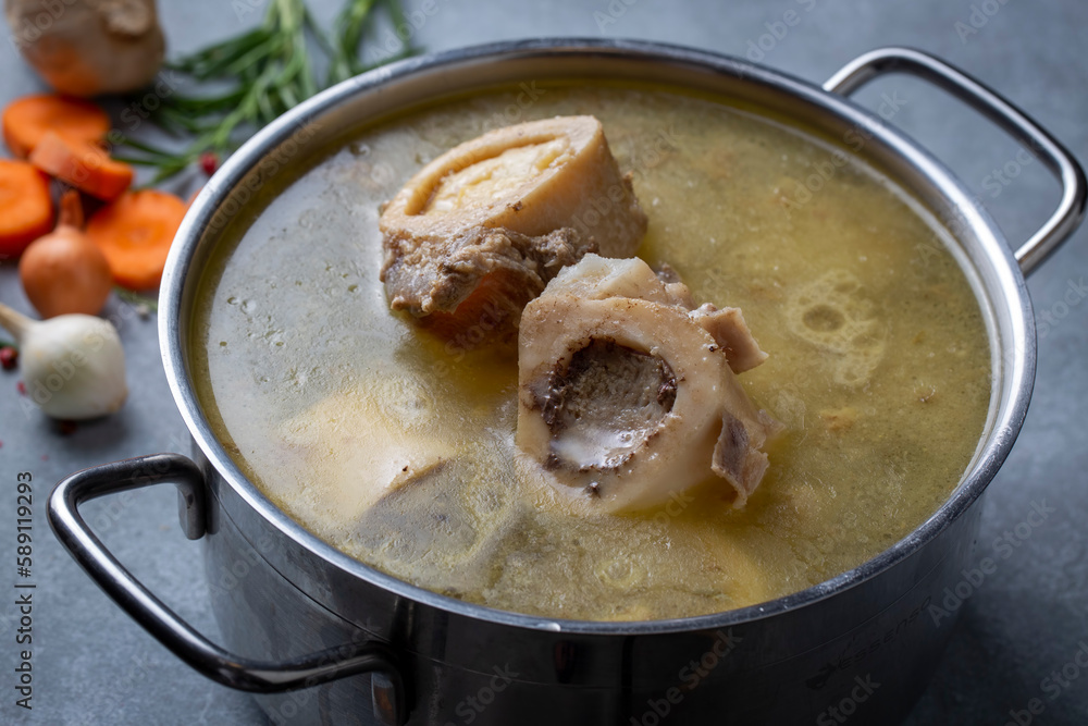 Boiled bone and broth. Homemade beef bone broth is cooked in a pot on. Bones contain collagen, which provides the body with amino acids, which are the building blocks of proteins. Boiled bone and broth. Homemade beef bone broth is cooked in a pot on. Bones contain collagen, which provides the body with amino acids, which are the building blocks of proteins.