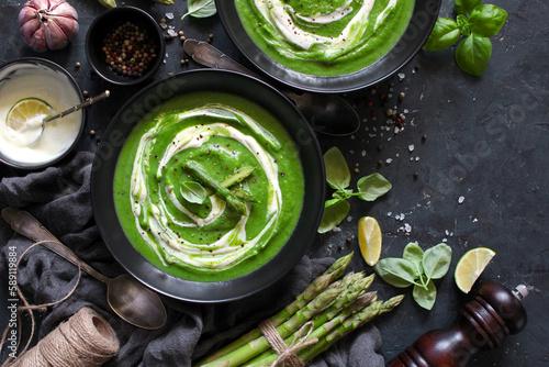 Asparagus cream soup on dark table. Healthy food. Top view.