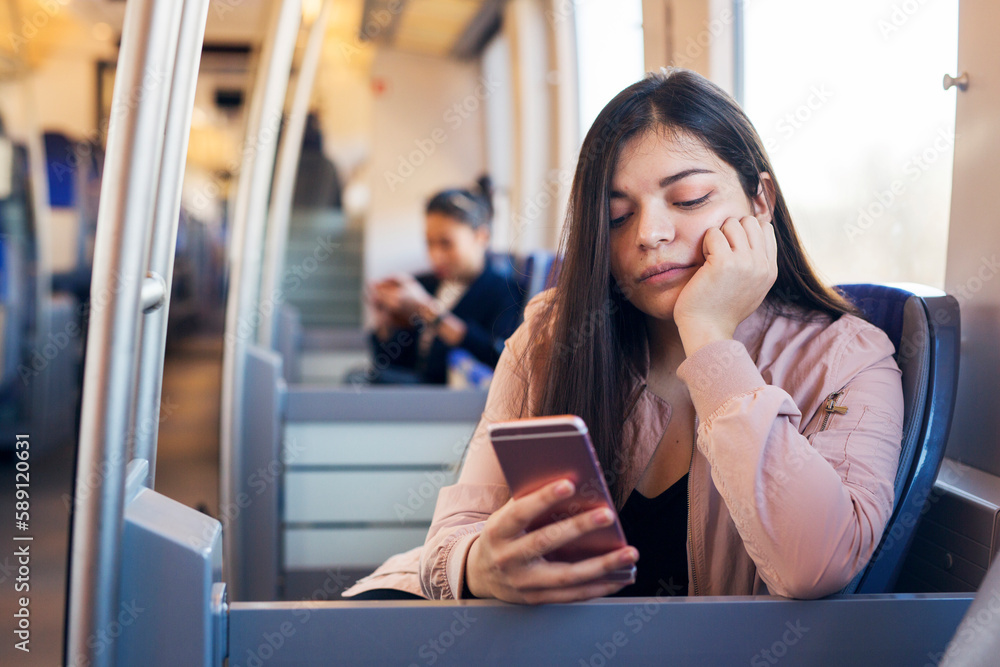 Woman using smart phone in train Woman using smart phone in train