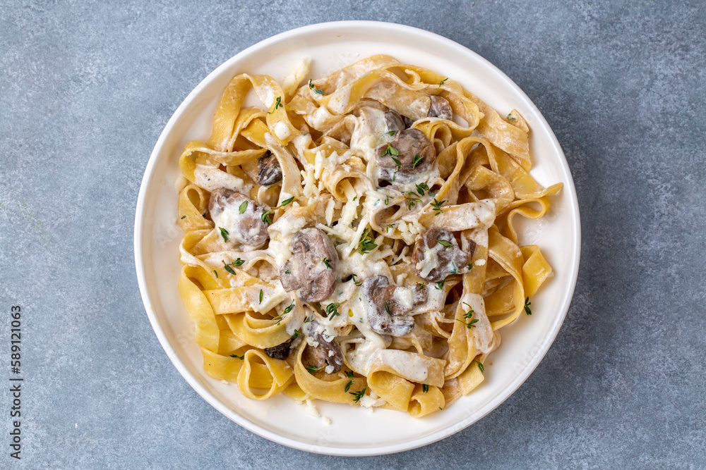 Homemade Italian fettuccine pasta (Fettuccine al Funghi Porcini) with mushroom and cream sauce. Traditional Italian cuisine.