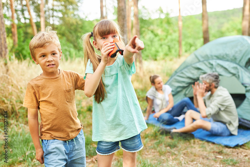 Siblings exploring while hiking together in forest