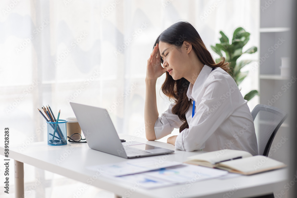Asian women are stressed or has sore throat at office while working on laptop, Tired asian businesswoman with headache at office, feeling sick at work, copy space Asian women are stressed or has sore throat at office while working on laptop, Tired asian businesswoman with headache at office, feeling sick at work, copy space