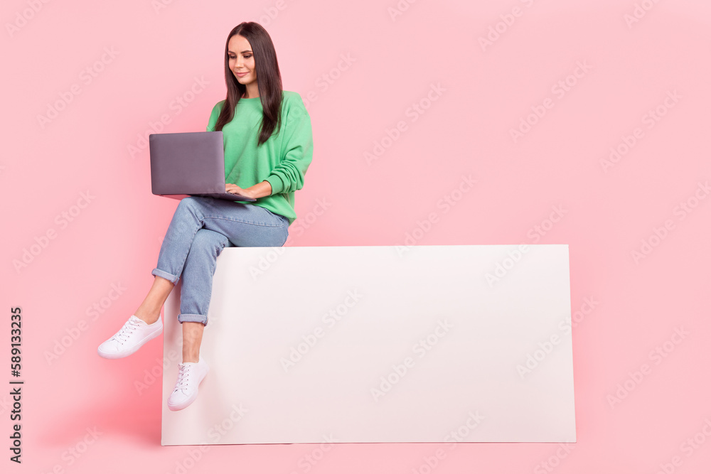 Photo of gorgeous successful lady wear trendy clothes write email read news use novelty sit empty space isolated on pink color background Photo of gorgeous successful lady wear trendy clothes write email read news use novelty sit empty space isolated on pink color background