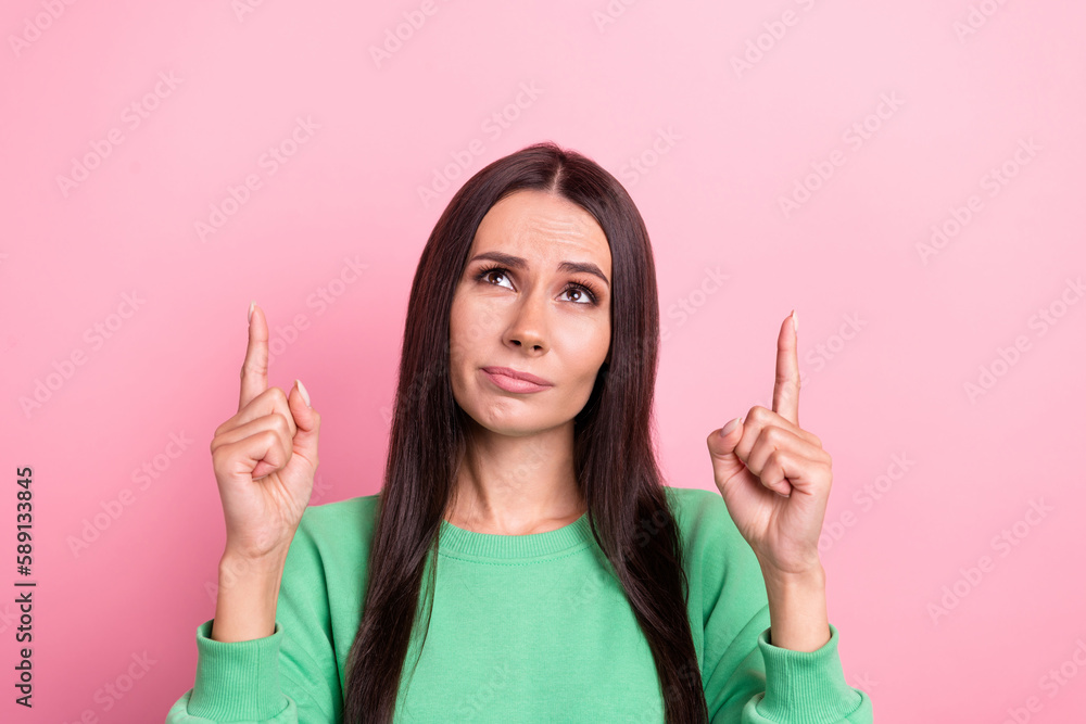 Portrait of young intelligent business woman wear green pullover direct fingers up look interested news copyspace isolated on pink color background Portrait of young intelligent business woman wear green pullover direct fingers up look interested news copyspace isolated on pink color background