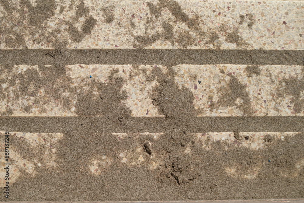 Fototapeta premium Some bricks filled with sand on a promenade next to the tourist beach
